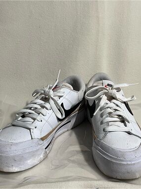 Nike White Low-Top Sneakers with Black Swoosh and Tan Accent